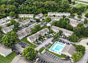 Thumbnail 33 of 35 - An aerial view of a residential complex with a swimming pool.