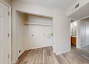 Thumbnail 10 of 35 - A room with a white door and a wooden floor.