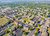 Thumbnail 23 of 23 - an aerial view of a neighborhood with cars parked in a parking lot