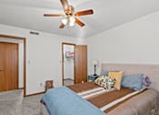 Thumbnail 11 of 23 - a bedroom with a large bed and a ceiling fan