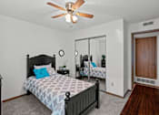 Thumbnail 8 of 23 - a bedroom with a bed and a ceiling fan