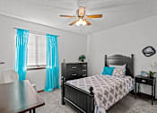 Thumbnail 6 of 23 - a bedroom with a bed and a ceiling fan