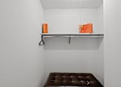 Thumbnail 9 of 23 - a brown bench in a white room with a shelf