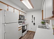 Thumbnail 5 of 23 - a kitchen with a stove refrigerator and sink