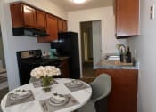 Thumbnail 1 of 15 - Connected living and dining area at West Broadway Apartments