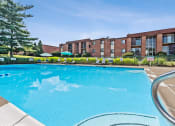 Thumbnail 11 of 12 - a large swimming pool with an apartment building in the background