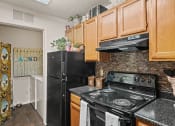 Thumbnail 7 of 31 - apartment kitchen with a stove and a refrigerator