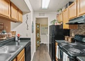 Thumbnail 8 of 31 - a kitchen with black appliances and wood cabinets