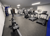 Thumbnail 11 of 13 - a spacious fitness center with treadmills and other exercise equipment