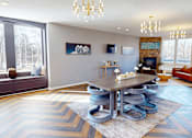 Thumbnail 21 of 27 - A modern living room with a large table and chairs.