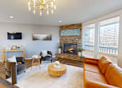 Thumbnail 20 of 27 - A living room with a fireplace and a tv on the wall.