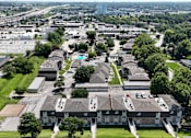 Thumbnail 32 of 33 - A bird's eye view of a residential area with houses and apartment buildings.