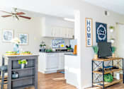 Thumbnail 3 of 26 - a kitchen and living room with a ceiling fan