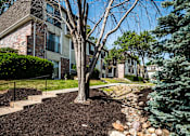 Thumbnail 24 of 26 - a tree in front of an apartment building