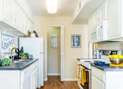 Thumbnail 4 of 26 - a kitchen with white cabinets and white appliances