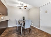 Thumbnail 6 of 35 - A dining room with a table and chairs.