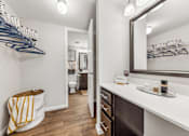 Thumbnail 15 of 35 - A bathroom with a white counter and a mirror.