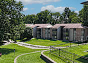 Thumbnail 33 of 35 - A black iron fence surrounds a green lawn.
