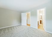 Thumbnail 22 of 35 - A room with carpeted floor and two open doors.