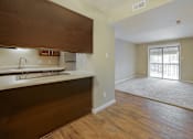 Thumbnail 21 of 35 - A kitchen with wooden cabinets and a sink.