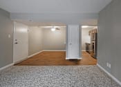 Thumbnail 19 of 35 - A room with a white door and a grey carpet.