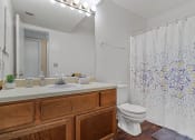 Thumbnail 13 of 28 - a bathroom with a toilet and a sink and a shower