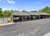 Thumbnail 23 of 28 - a parking lot with carports at apartment complex