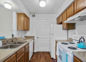 Thumbnail 1 of 28 - apartment kitchen with a stove, sink, and a refrigerator