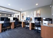 Thumbnail 12 of 17 - an office with desks and computers and chairs