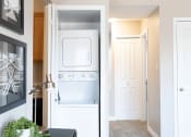 Thumbnail 7 of 17 - an in-home laundry room with a washer and dryer and a closet with a door