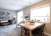 Thumbnail 1 of 17 - a dining room with a wooden table and chairs