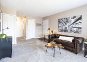 Thumbnail 4 of 17 - a living room with a couch and a coffee table