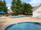 Thumbnail 12 of 14 - resident swimming pool with chairs and umbrellas