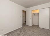 Thumbnail 7 of 14 - a bedroom with a closet and a door to a closet