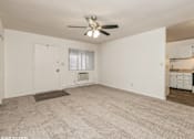 Thumbnail 6 of 14 - an empty living room with a ceiling fan
