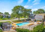 Thumbnail 18 of 22 - a swimming pool with chairs and umbrellas