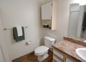 Thumbnail 3 of 34 - a bathroom with a toilet and a sink and a mirror