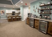 Thumbnail 10 of 34 - a kitchen with a counter and a bar with stools