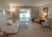 Thumbnail 1 of 34 - a living room with a couch and chairs and a sliding glass door