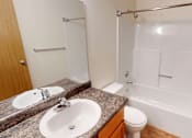 Thumbnail 10 of 19 - A bathroom with a sink, toilet, and bathtub.