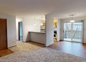 Thumbnail 5 of 19 - A spacious living room with a kitchen area in the background.