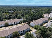 Thumbnail 25 of 26 - A bird's eye view of a residential area with houses and trees.
