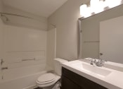 Thumbnail 8 of 22 - a bathroom with a sink toilet and a mirror
