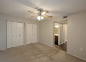 Thumbnail 7 of 22 - an empty living room with a ceiling fan and closet