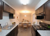 Thumbnail 1 of 22 - full kitchen and dining room with stainless steel appliances and wood flooring