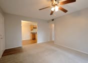 Thumbnail 11 of 22 - an empty living room with a ceiling fan