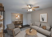 Thumbnail 3 of 22 - an open living room and dining room with a ceiling fan
