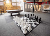 Thumbnail 8 of 25 - A giant chess board at apartment community game room