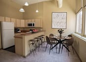 Thumbnail 6 of 30 - A kitchen with a table and chairs.