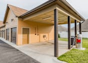 Thumbnail 20 of 22 - A garage with a carport attached to it.